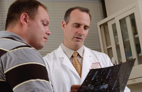 Resident doctor and trainee studying clinical guidelines