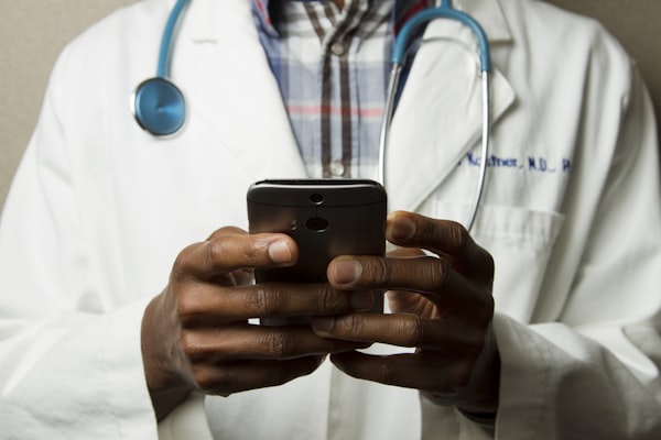 Doctor conducting telehealth consultation with ambient AI documentation